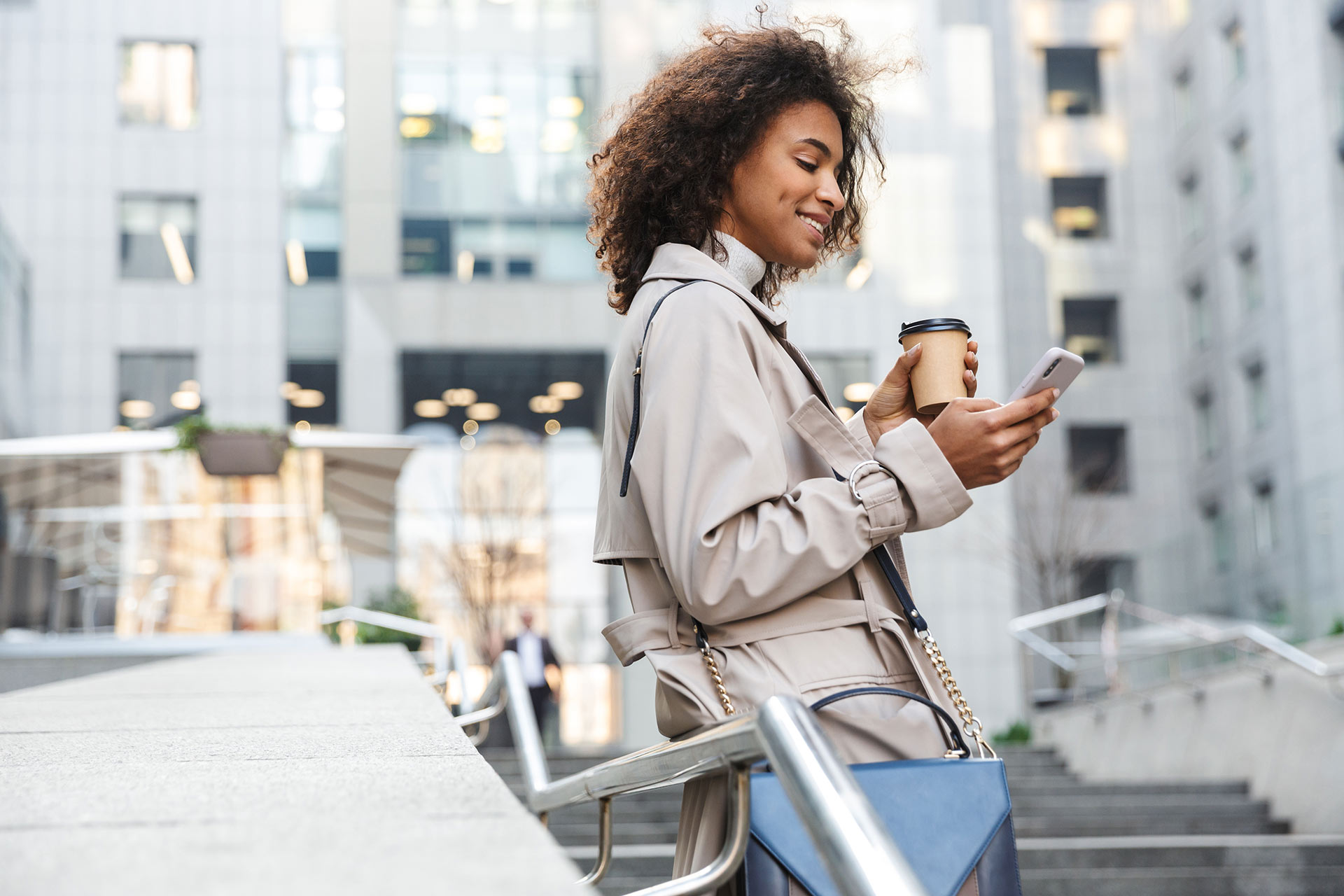Woman drinking coffee and watching at mobile